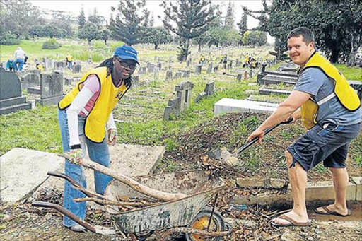RESTORING RESPECT: Church members Nonhlanhla Canham and Shaun Thornhill got stuck in clearing the Cambridge Cemetery on Saturday along with 90 fellow members of the Mormon Helping Hands Picture: BARBARA HOLLANDS