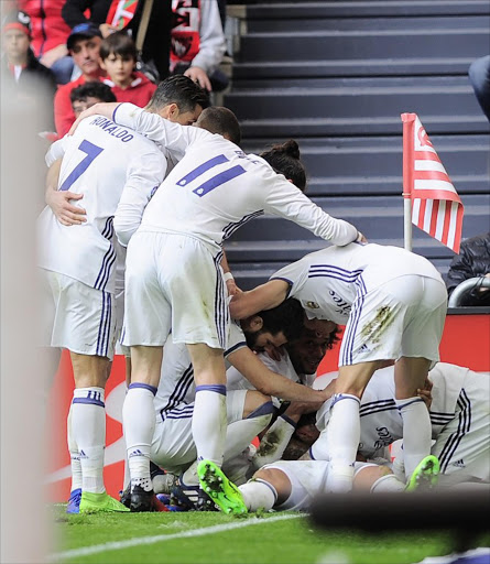 Real Madrid's players celebrate after Brazilian midfielder Carlos Henrique Casemiro scored their team's second goal during the Spanish league football match Athletic Club Bilbao vs Real Madrid CF at the San Mames stadium in Bilbao on March 18, 2017.
