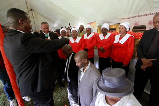CALLING FOR DIVINE INTERVENTION: AmaXhosa King Mpendulo Zwelonke Sigcawu and Western Thembuland King Siyambonga Dalimvula Matanzima are prayed for and anointed with holy oil at the national day of prayer hosted by King Sigcawu at Nqadu Great Place near Willowvale yesterday Picture: LULAMILE FENI