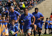 Western Force captain Matt Hodgson (C) leads his team out to start the Super Rugby match between Australia’s Western Force and South Africa’s Kings in Perth on April 9, 2017.