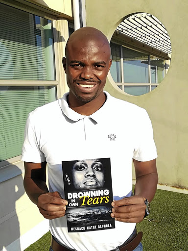 Meshack Mathe Bevhula proudly holds his published book Drowning in Own Tears.