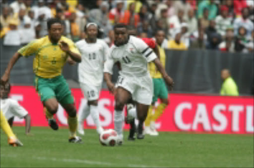 MacBeth Sibaya fight for the ball with Christopher Katongo during the 2008 MTN African Cup of Nations Qualifier match at Newlands Stadium in Cape Town. Zambia won 3-1. Pic. Antonio Muchave. 01/09/07. © Sowetan.