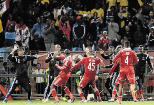 FIRING: Orlando Pirates striker Lehlohonolo Majoro celebrates his goal with teammates during their Absa Premiership match against Mamelodi Sundowns at Loftus Stadium in Pretoria on Wednesday night PHoto:Lefty Shivambu/Gallo Images