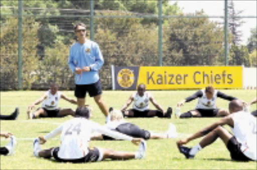 STRETCHED: Kaizer Chiefs' coach Muhsin Ertugal takes his charges through training at Naturena in Johannesburg yesterday. Pic. Mohau Mofokeng. 14/10/2008. © Sowetan.