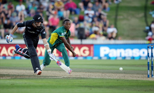 Tim Southee of New Zealand (L) looks for a run as South Africa's Kagiso Rabada (R) tries to run him out during the one-day international (ODI) cricket match between New Zealand and South Africa at Seddon Park in Hamilton on February 19, 2017.