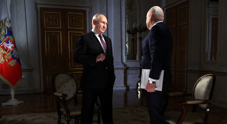 Russian President Vladimir Putin speaks with director-general of Rossiya Segodnya media group Dmitry Kiselyov during an interview in Moscow, Russia, March 12 2024. Picture: REUTERS./Gavriil Grigorov/Sputnik