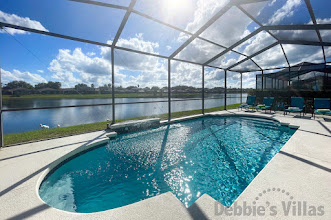 Gorgeous lake view for the sun drenched pool deck at this Sunset Lakes vacation villa