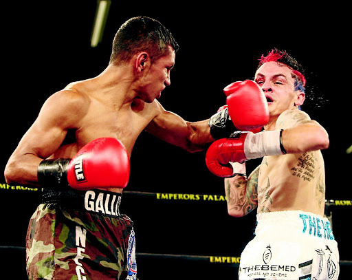 Defeated: Byron Rojas of Nicaragua, left, fights with SA's Hekkie Budler when Budler lost his crown. Picture credits: ANTONIO MUCHAVE