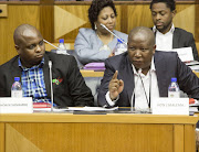 Leader of the EFF Julius Malema raises his final point of order before deciding to lead his EFF members from the disciplinary hearing at the National Assembly. Picture credit: Halden Krog