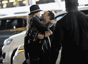 US singer and songwriter John Legend greets his supermodel wife, Chrissy Teigen, on her arrival at Cape Town International Airport