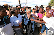 Nomaza Nomandela, centre, was part of a group of protesters who invaded land in Hermanus. She also received an SMS demanding she pay rates. 