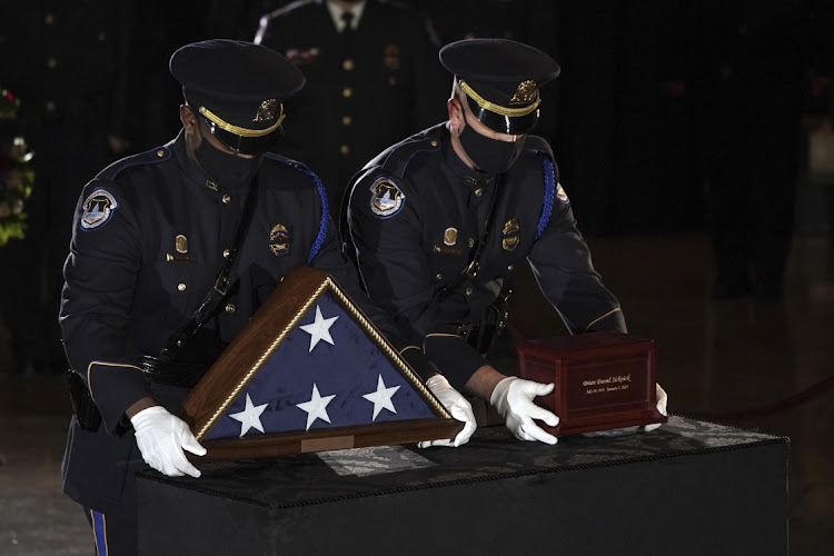 U.S. Capitol Police Officers place the remains of officer Brian Sicknick in the Capitol Rotunda of the U.S. Capitol in Washington, D.C., U.S., on Tuesday, Feb. 2, 2021.