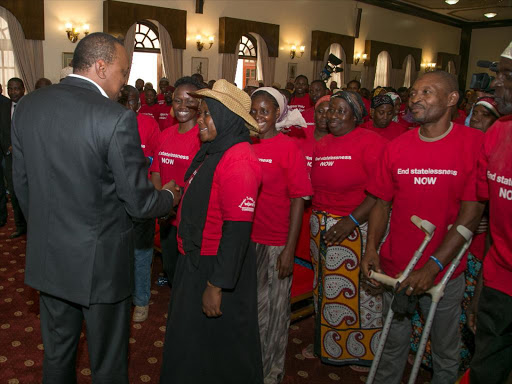 President Uhuru Kenyatta chats with members of the stateless Makonde community at State House, Nairobi, on Thursday /PSCU