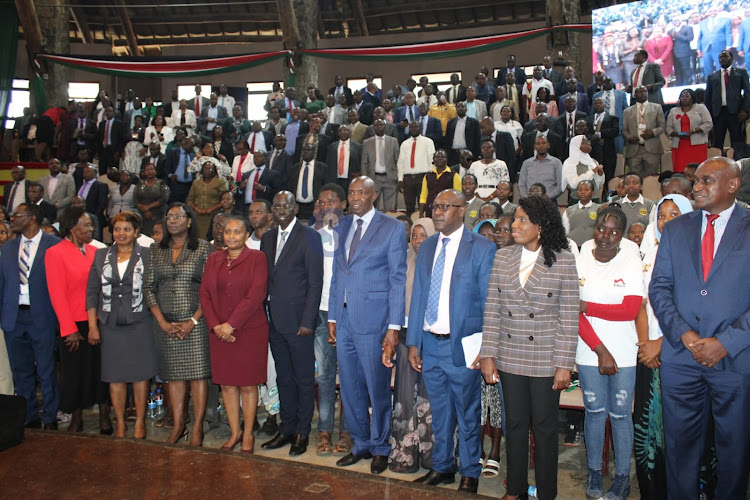 Education Cabinet Secretary Ezekiel Machogu and Basic Education Principal Secretary Belio Kipsang pose for a photo with of officials and education stakeholders during the launch of the 2024 Elimu scholarship program at the Bomas of Kenya, Nairobi on January 19, 2023