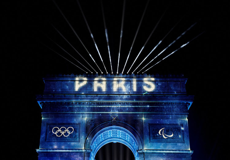 'Paris' is projected onto the Arc de Triomphe to celebrate entry into the Olympic year during New Year's celebrations on the Champs Elysees avenue in Paris. Public transport agents will use AI-supported translation devices to help hundreds of thousands of visitors navigate the French capital's network during the 2024 Olympic Games. File photo.