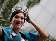 Miss Universe 2015 Pia Alonzo Wurtzbach from the Philippines holds her crown as she waves to the crowd during a motorcade at Makati financial district in Manila. REUTERS/Erik De Castro/File Photo