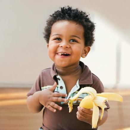 A boy eating a banana