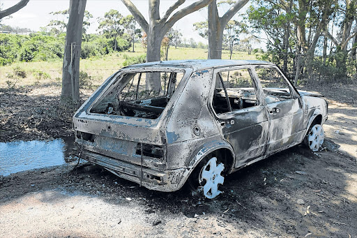 LUCKY ESCAPE: A hijacked VW Golf was set alight near the Ncera turn-off yesterday Picture: ALAN EASON
