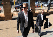 TV host Gareth Cliff arrives at the Johannesburg high court for the ruling against his layoff. AFP / STRINGER