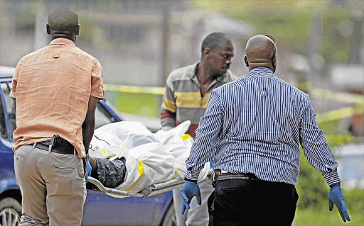The body of IFP member Siya Dlamini is removed after he was shot dead outside the Ntuzuma Magistrate's Court. File photo.