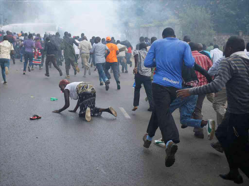 Protesters run away from the police during clashes in Nairobi, Kenya May 16, 2016. REUTERS/Goran Tomasevic