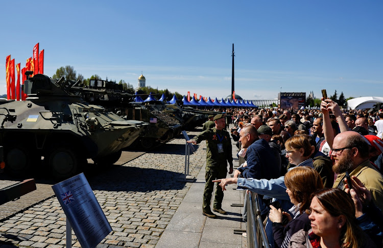 Visitors stand behind barriers while looking at military hardware at an exhibition, which displays armoured vehicles and equipment captured by the Russian army from Ukrainian forces in the course of Russia-Ukraine conflict, at Victory Park open-air museum on Poklonnaya Gora in Moscow, Russia, on May 1 2024.