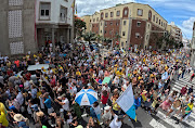 People march down a street in Santa Cruz de Tenerife, Spain, calling for change to the Canary Islands' tourism model. 