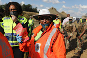 Mpumalanga community safety MEC Gabisile Tshabalala (in yellow) and her Gauteng counterpart Faith Mazibuko (in orange) at the roadblock on the N4 highway on Friday.