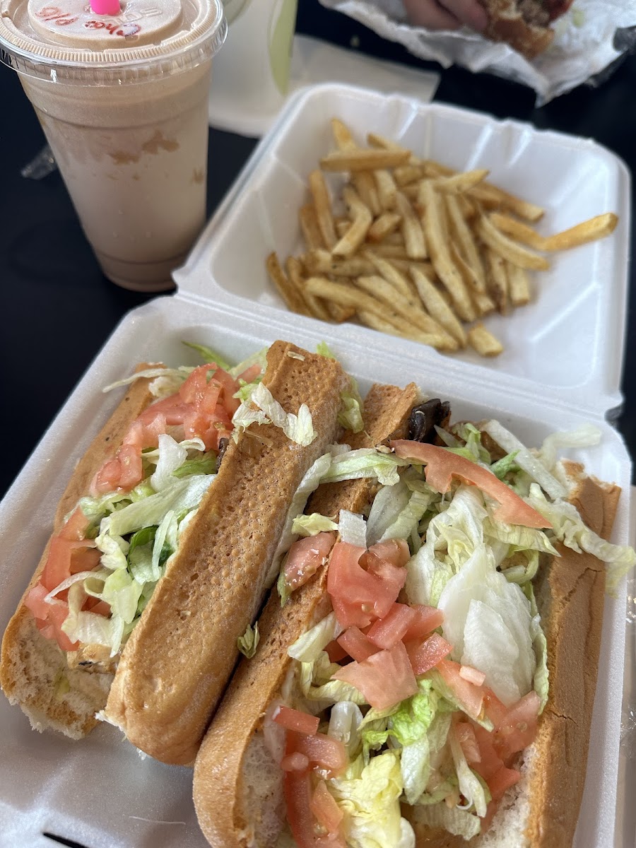 Chicken cheesesteak with mushrooms, onions, lettuce, tomato, and mayo; chocolate peanut butter milkshake; and french fries