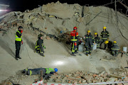 Rescue teams are listening for sounds of life from workers trapped under concrete at the construction site in George.