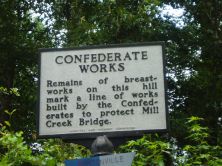 Remains of breastworks on this hill mark a line of works built by the Confederates to protect Mill Creek Bridge.Plaque via North Carolina Highway Historical Marker Program, and is used with their...