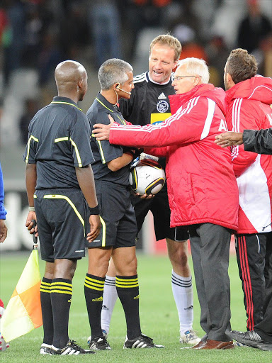 A file photo of Hans Vonk (M) of Ajax Cape Town and his head coach Foppe de Haan (R) arguing with referee Abdul Ebrahim after Santos scored from the penalty spot during the Absa Premiership match at Cape Town Stadium on October 15, 2010 in Cape Town, South Africa.