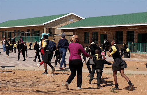 Parents call pupils at Ntji Mothapo Primary School in Limpopo to their classrooms after they forcefully removed the teachers who were against the installation of CCTV cameras. Photo: SANDILE NDLOVU