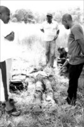 ROUGH JUSTICE: The body of a man killed by a mob that accused him of burglary. Pic. Lucky Nxumalo. © Sowetan.