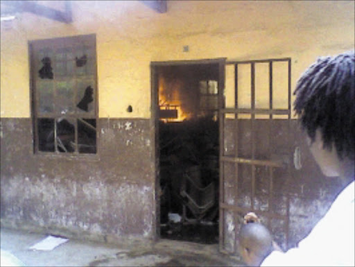 IN FLAMES: Pupils set two classrooms ablaze at Sebalamakgolo High School in Namakgale after the postponement of a trip to Polokwane. Pic: Alex Matlala. 03/03/2010. © Sowetan.