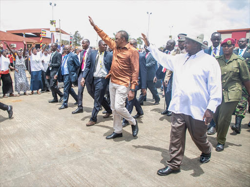 President Uhuru Kenyatta and President Yoweri Kaguta Museveni of Uganda acknowledge greetings from wananchi moments after commissioning the Busia One Stop Border Post, January 24. /PSCU