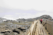 THIS WAY: A wooden walkway leads to a replica cross at Diaz Point, Luderitz, Namibia