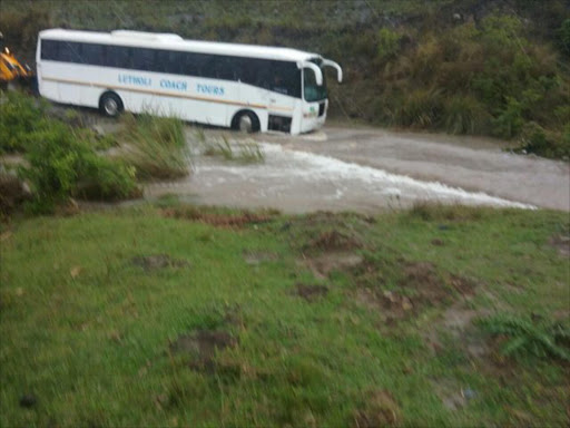 NO WAY THROUGH: A bus carrying over 15 school was stuck in an overflowing river in Nzulwini area. Picture: SUPPLIED