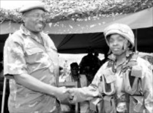 WELL DONE: Young paratrooper Mantoa Leburu is congratulated by Lieutenant-General Solly Shoke. Pic. Michael Tlhakudi. © Sowetan.