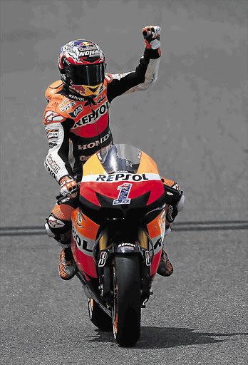 Honda MotoGP rider and defending world champion, Casey Stoner of Australia, celebrates victory in the Spanish Grand Prix yesterday Picture: MARCELO DEL POZO/REUTERS