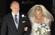 Former England rugby captain Mike Tindall and Zara Phillips, the eldest granddaughter of Queen Elizabeth, leave Canongate Kirk in Edinburgh, Scotland, after getting married