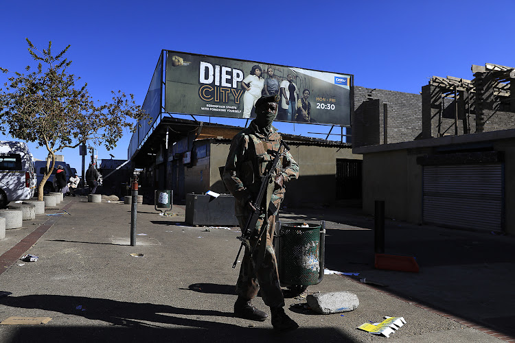 A soldier patrols in Soweto last week after violent protests and looting. File photo.