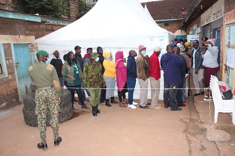 Police officers guarding Murang'a town Social hall as voters cast their votes.