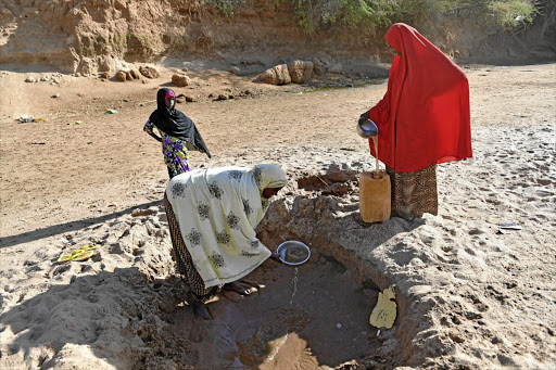 Women collect water from a river bed near Doolow, Somalia, on the border with Ethiopia.