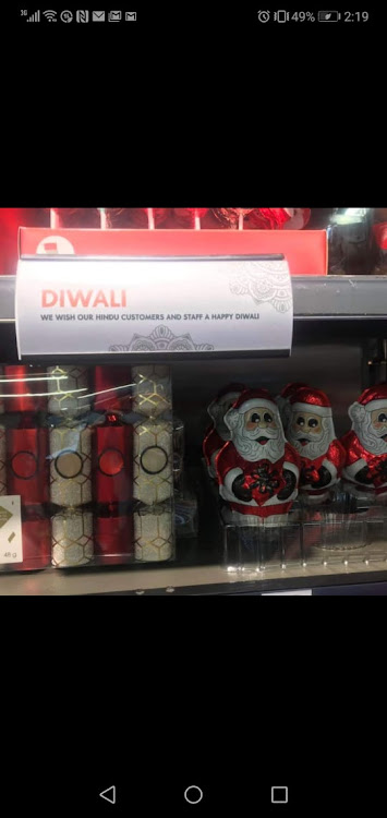 A sign placed above Christmas decorations in a Woolworths store wished Hindu customers and staff a happy Diwali.