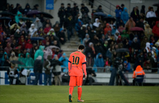 Barcelona's Argentinian forward Lionel Messi walks during the Spanish league football match Getafe CF vs FC Barcelona at the Col. Alfonso Perez stadium in Getafe on December 13, 2014. AFP PHOTO / DANI POZO