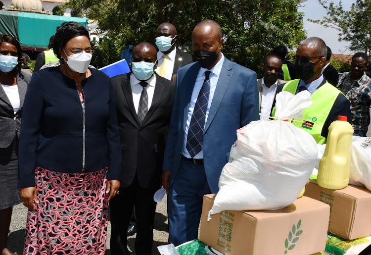 Public Service CS Prof Margaret Kobia with Direct Aid officials in Thika on Tuesday while flagging off 340 tons of relief food.