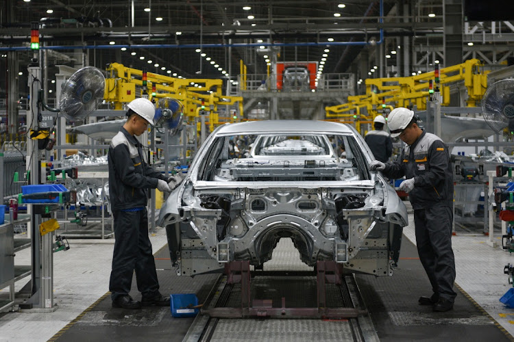 Technicians at work in VinFast's factory in Hai Phong City, Vietnam. The EV company achieved an $85bn valuation in its Nasdaq debut. Picture: THANH HUE