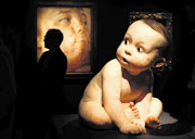 HERE'S LOOKING AT YOU, BABY: Ron Mueck's 'Big Baby' sculpture appears to look around at Jenny Saville's painting 'Interfacing' at Christie's in London, England Picture: PETER MACDIARMID/GALLO IMAGES