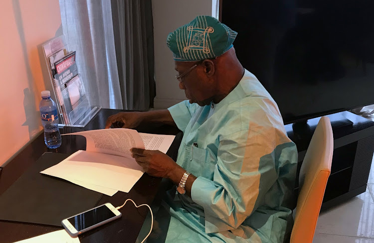 Olusegun Obasanjo, former Nigerian president and chairman of the West Africa Commission on Drugs, looks at documents during an interview in Dakar, Senegal, on September 11 2018.